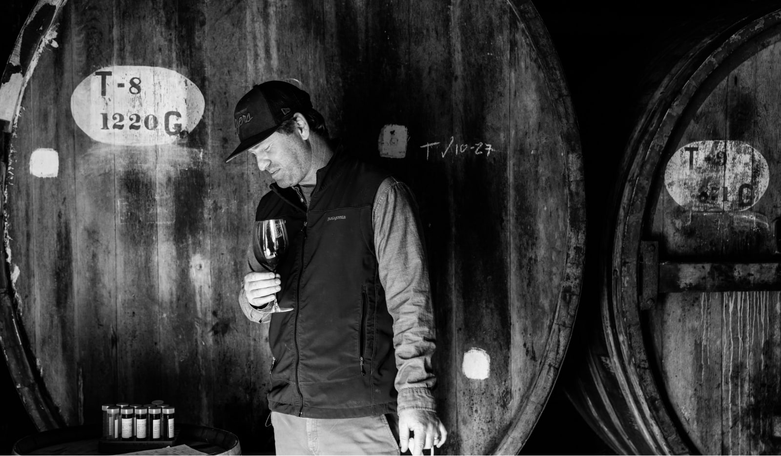 Mayacamas winemaker sampling red wine near fermentation barrels