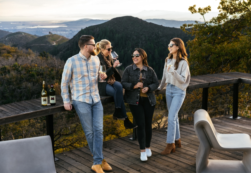 Four people drinking wine on Mayacamas deck