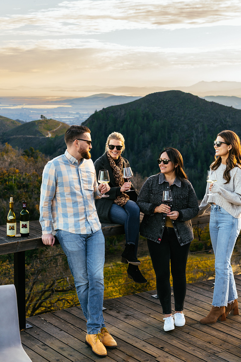 Four people drinking wine on Mayacamas deck
