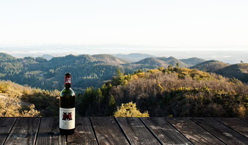 Bottle of Mayacamas wine on a desk overlooking the mountains