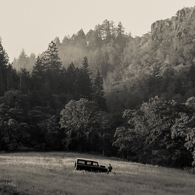 Man and old truck in field