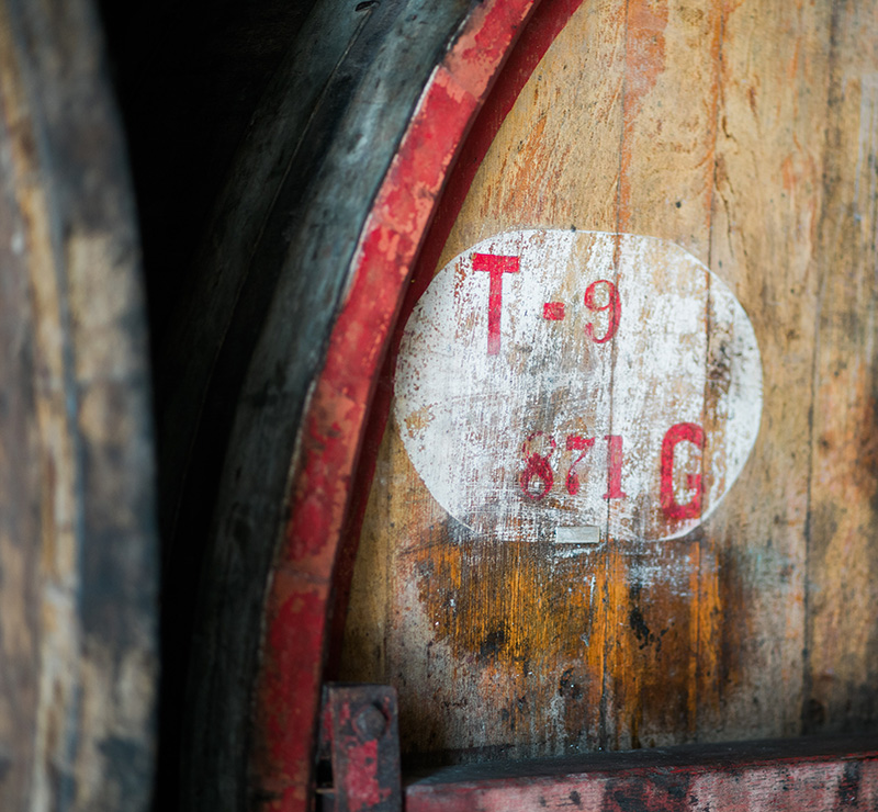 Large wooden wine barrel with red inscriptions