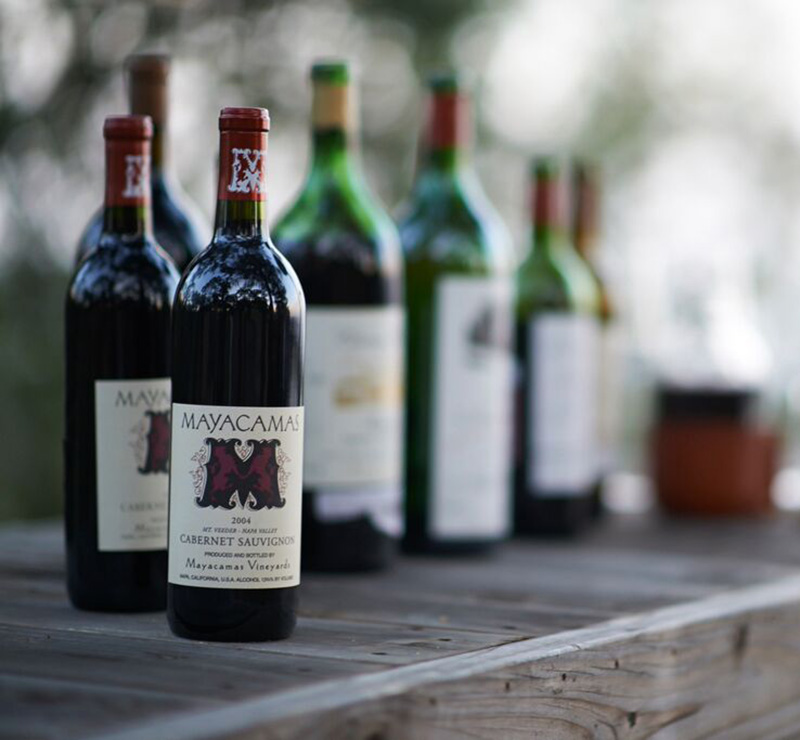 Bottles of Mayacamas wines on wooden shelf